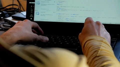 Bearded middle age on code of developing software at dark room on laptop  Stock Footage 105337260