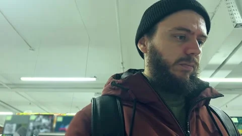 Bearded middle-aged man examines a book in the library Stock Footage 265023252