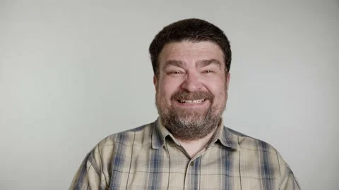 Bearded middle aged man in gray blue shirt isolated over gray background Stock Footage 156083860