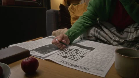 Bearded Middle Aged Man Solving Crossword Puzzle in Newspaper Stock Footage 341675122