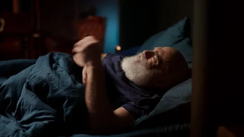 Bearded middle-aged man wakes up with headache after a sleepless night, insomnia Stock Footage 342520884