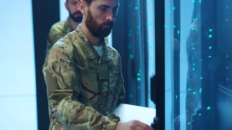 Bearded military man opens a server cabinet and downloading secret information 库存影片 121270860