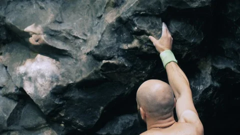 Bearded mountain climber man rises up the rock with the insurance. Extreme Stock Footage 102857232