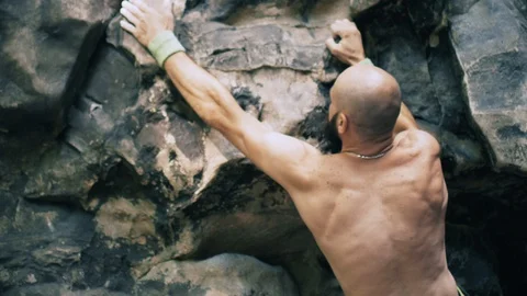 Bearded mountain climber man rises up the rock with the insurance. 4K UHD Video stock 103096488