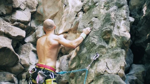 Bearded mountain climber man rises up the rock with the insurance.  4k UHD 2160p Stock Footage 103101624