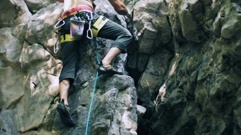 Bearded mountain climber man rises up the rock with the insurance. 4K UHD Stock Footage 103103530
