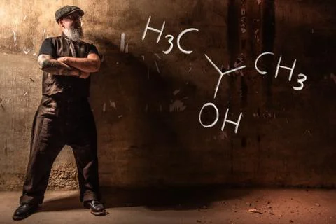 Bearded old man presenting handdrawn chemical formula of Isopropylalcohol iso 写真素材