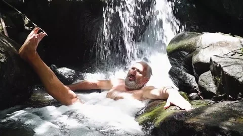 Bearded old man washes in the river Video stock 137555954