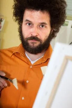Bearded painter in his studio Stockfoto's