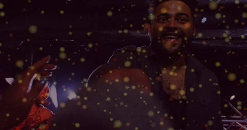 Bearded performer drumming as audience hands reaching, energizing concert via Video stock 334185344
