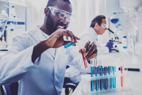 Bearded physician smiling while enjoying process of work 스톡 사진