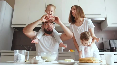 Bearded pleasant dad teaching to break eggs Stock Footage 117897445