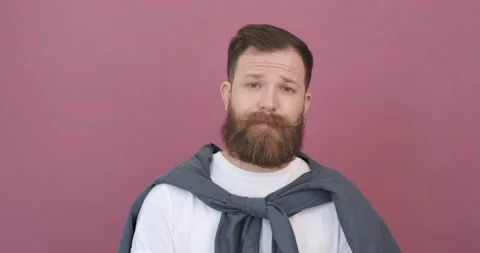 Bearded professional man on pink background. Emotions of real people. Stock Footage 155797698
