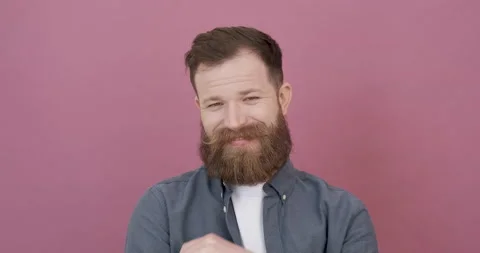Bearded professional man on pink background. Emotions of real people. Stock Footage 155797743
