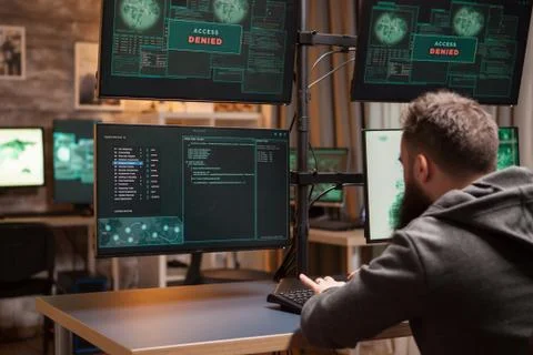 Bearded programmer hacking trying to steal information Fotos Stock