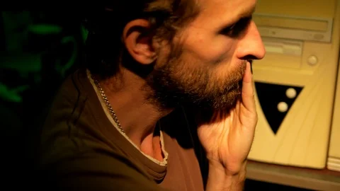 Bearded programmer working in a dark room and thinking about the code writing cl Stockbeeldmateriaal 95850696