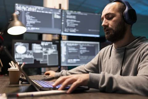 Bearded Programmer Working with Headphones in Modern Office Stock Photos