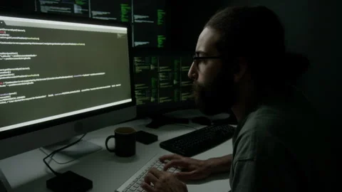 Bearded Programmer Writing Code, Sitting at Desk with Multiple Monitor Screens Video stock 302194251