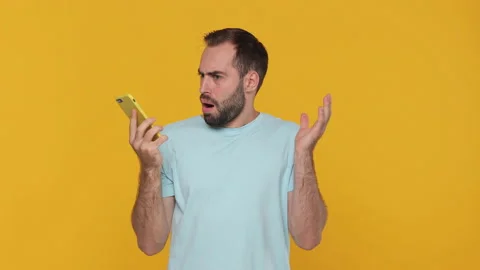 Bearded sad upset young man in basic casual blue t-shirt using speaking talking Video stock 148290554