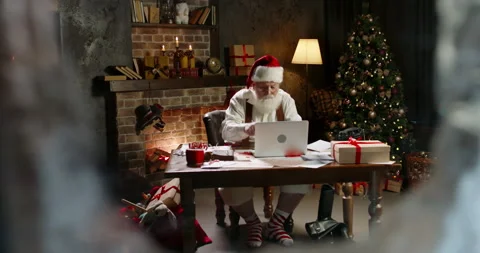 Bearded Santa Claus using laptop computer, typing on keyboard, buying New Year Video stock 162244815