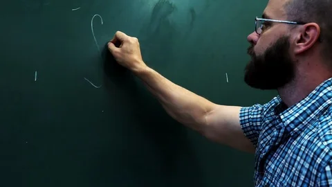 A bearded scientist writes the formula on a blackboard. Stock Footage 90371709