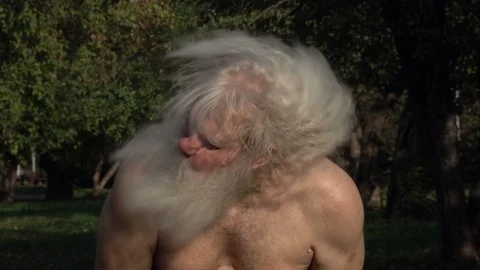 Bearded senior bare-chested man with splendid long hair shaking his head 動画素材 121030837
