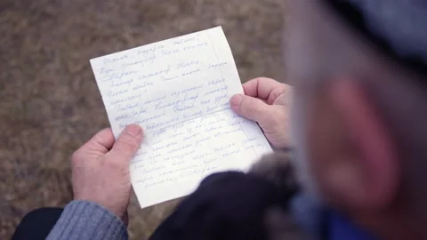Bearded senior man reads nope from granddaughter on street Stock Footage 229723604
