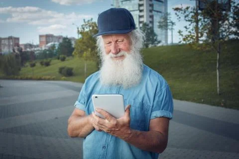 Bearded senior man using tablet Stock Photos