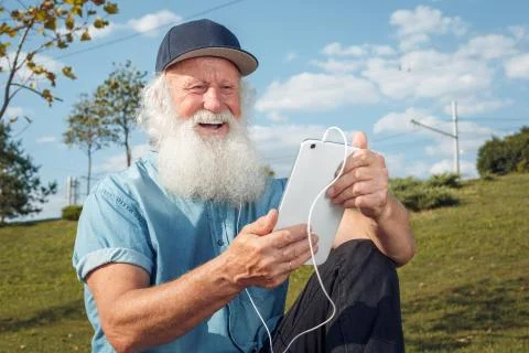 Bearded senior man using tablet Stock Photos