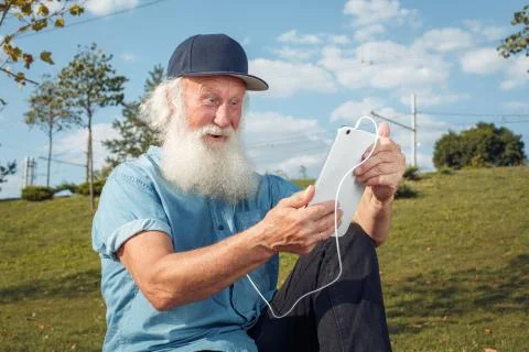 Bearded senior man using tablet Stock Photos