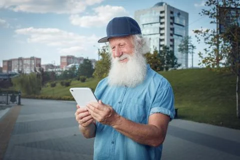Bearded senior man using tablet Stock Photos