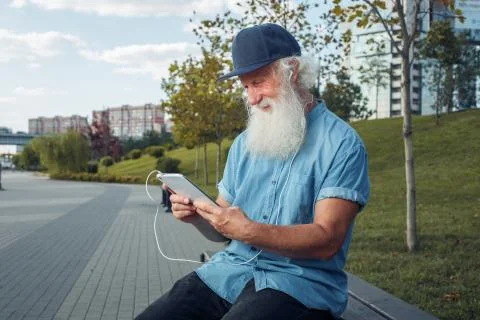 Bearded senior man using tablet Stock Photos