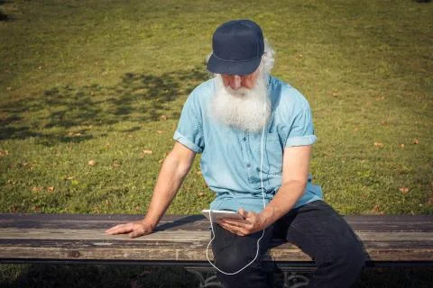 Bearded senior man using tablet Stock Photos