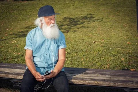 Bearded senior man using tablet Stock Photos