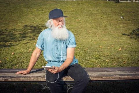 Bearded senior man using tablet Stock Photos