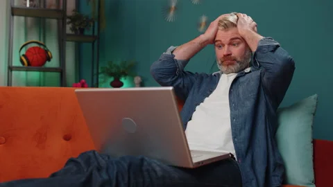 Bearded senior old man use laptop surprised by bad news, fortune loss, fail Stock Footage 228141728