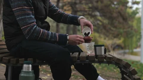 Bearded tea master puts tea in clay teapot for brewing. outdoors tea ceremony Stock Footage 229860573