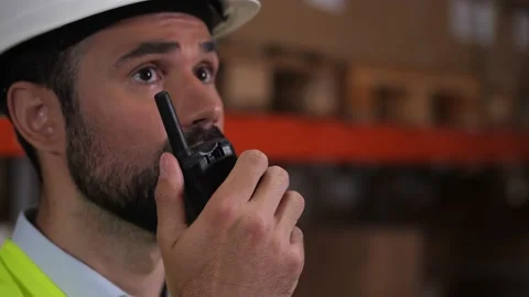 Bearded warehouse worker talking on walkie-talkie Stock Footage 161952102
