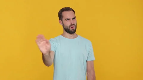 Bearded young guy 20s in basic casual blue t-shirt isolated on yellow background Stock Footage 148287944