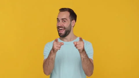 Bearded young man 20s in basic casual blue t-shirt isolated on yellow background Stock Footage 148286656