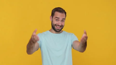 Bearded young man 20s in basic casual blue t-shirt isolated on yellow background Stock Footage 148286665