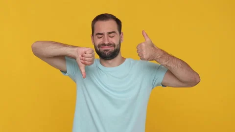 Bearded young man 20s in basic casual blue t-shirt on yellow background studio. Stock Footage 148287090