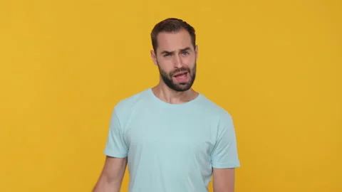 Bearded young man 20s in basic casual blue t-shirt isolated on yellow background Stock Footage 148287219