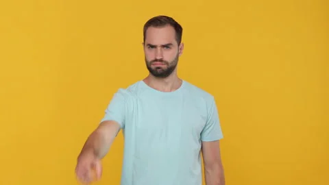 Bearded young man 20s in basic blue t-shirt isolated on yellow background Stock Footage 148287790