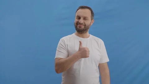 The bearded young man also nodded with his right hand, thumb all right. Stock Footage 148579630