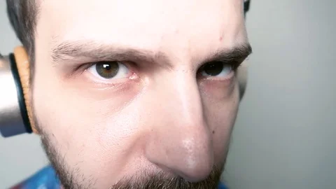 Bearded young man approaches the camera and looks into the camera Stock-Footage 109503228