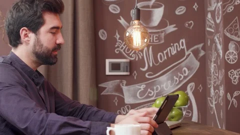 Bearded young man using his tablet to have a video chat Video stock 106703111