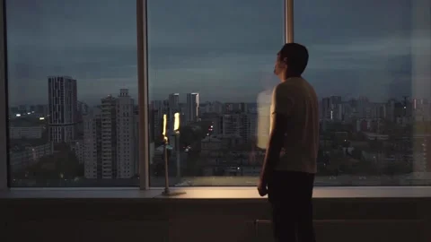 Bearded young man by the window in despair Stock Footage 162037357