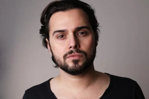 Bearded young stylish man posing indoor looking at the camera. Mindset concept. Fotos Stock