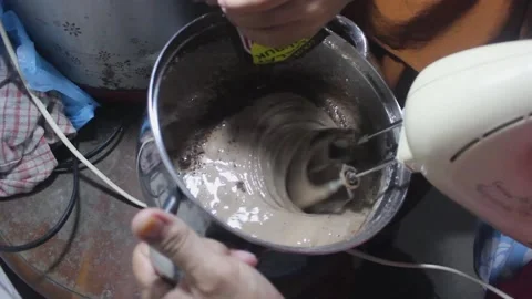 Beat the cookie dough using a mixer Stock Footage 272285518